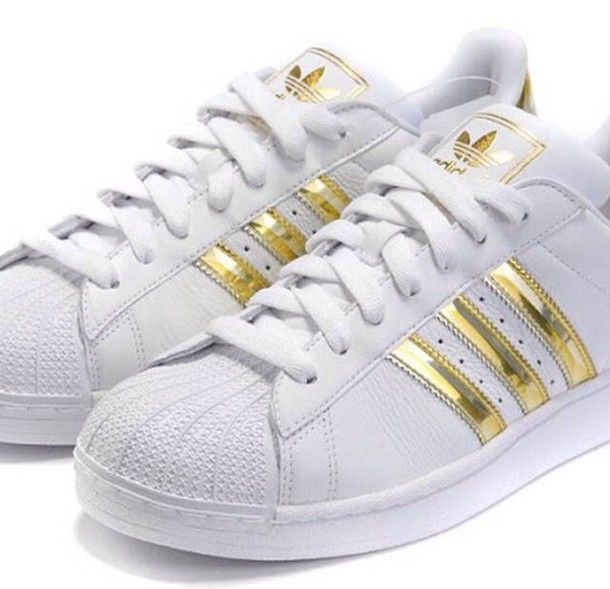 white sneakers with gold stripes